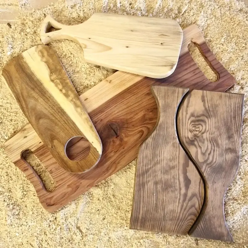 Selection of handmade walnut and oak serving boards with handles