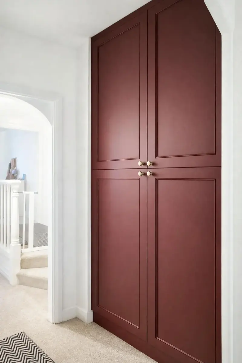Pair of tall painted shaker-style cupboard doors in burgundy with brass handles