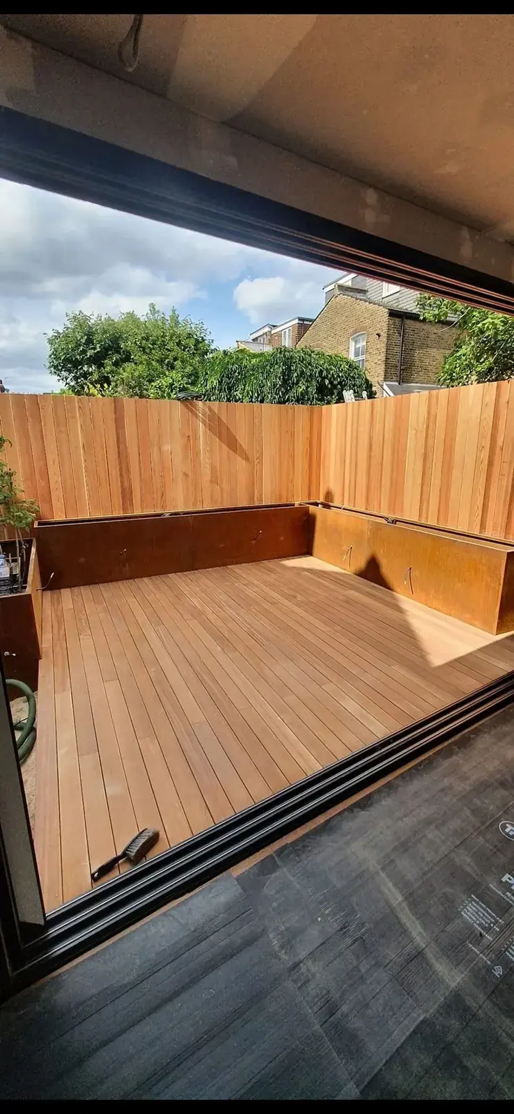 Timber deck with built-in benches along new close-boarded fencing