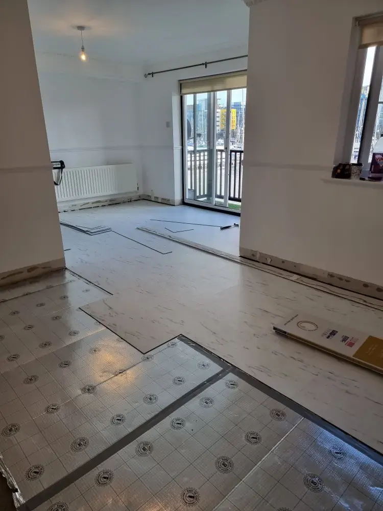 Room mid-way through a floor installation with underlay and new boards