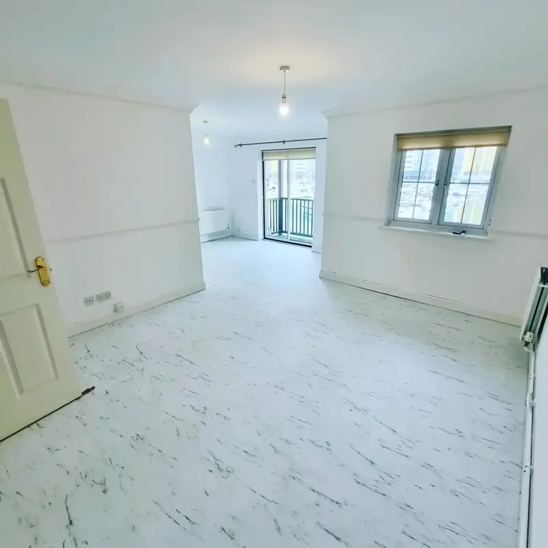 Empty room with newly laid white marble-effect floor