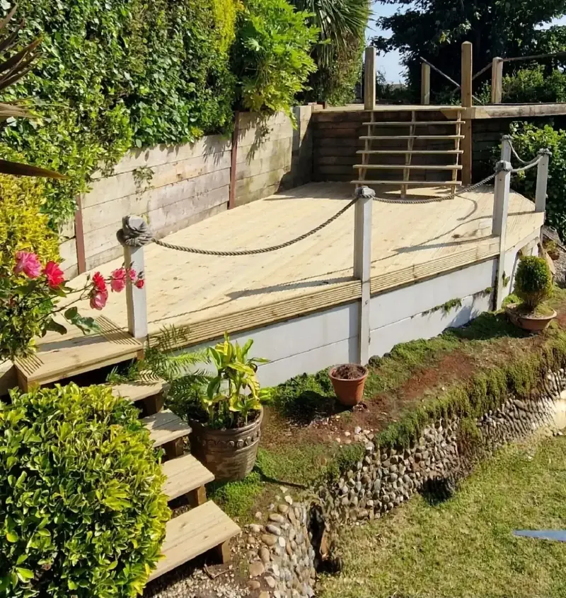 Garden terrace with timber edging, rope handrail and planting