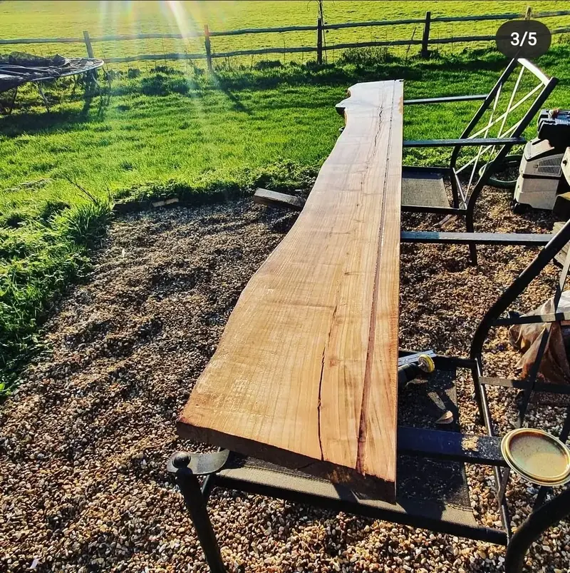 Long live-edge timber slab resting outdoors