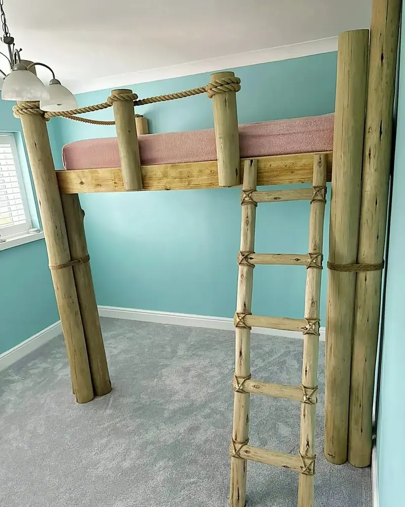 Child's raised loft bed built from round timber posts with a ladder