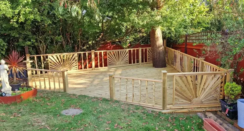 Low garden fence with a sunburst pattern gate