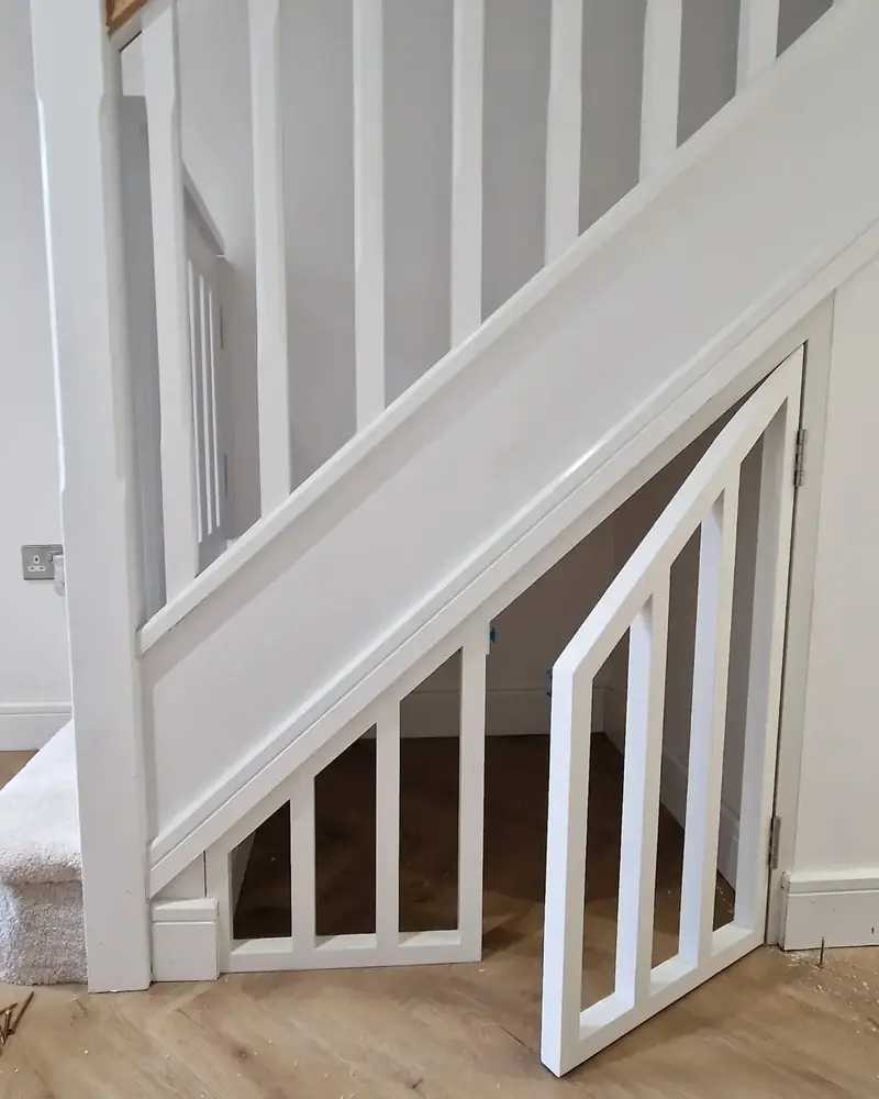 White angled door fitted to the triangle under a staircase