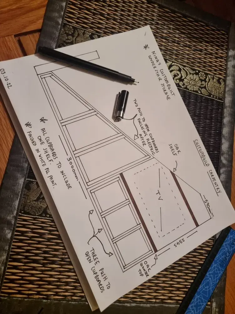 Pencil drawing of an under-stairs unit with measurements