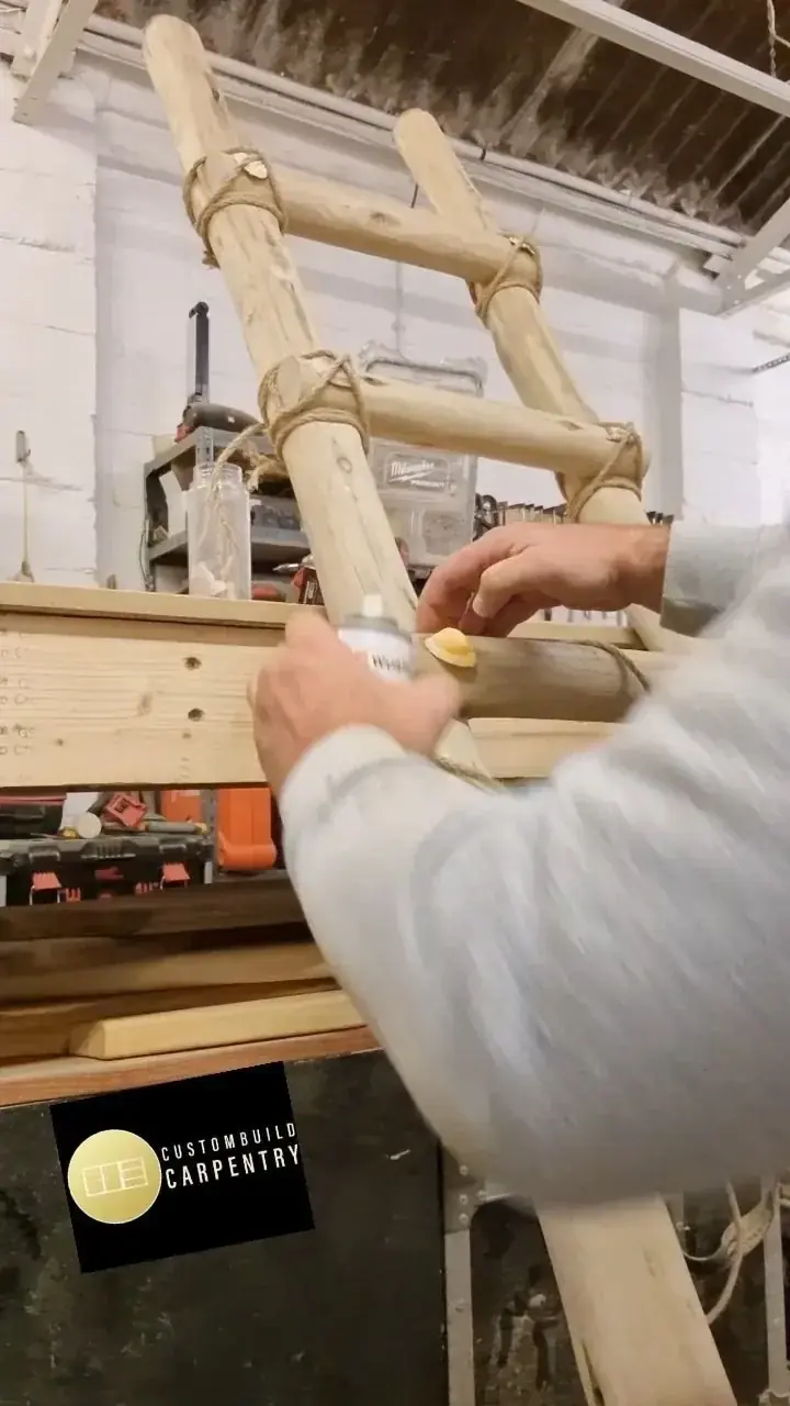 Hands shaping a timber ladder in the workshop